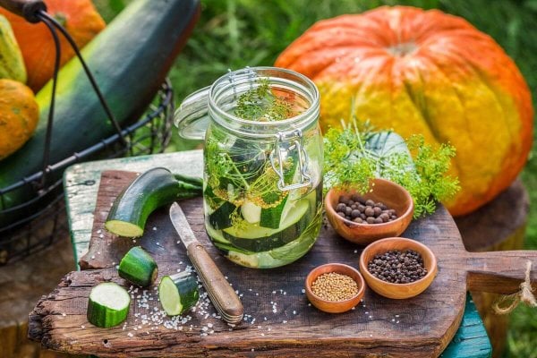 Zucchini pickle ingredients and a jar of zucchini pickles.