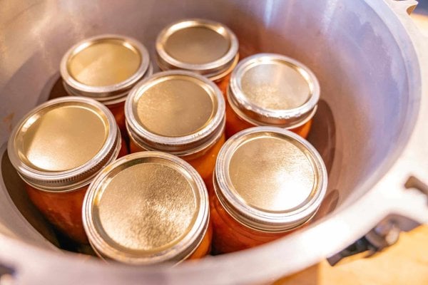 Canning jars sitting inside a pressure canner.