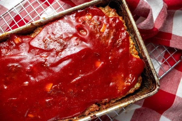 Close overhead view of glazed meatloaf in a loaf pan.