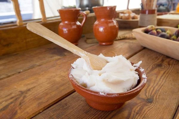 rendered-solidified-lard A bowl filled with solid lard sitting on a wooden counter top.